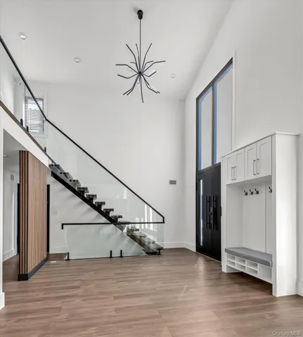 a view of an entryway wooden floor and stairs