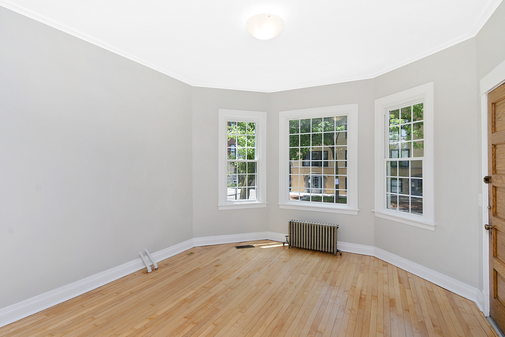 4017 North Spaulding Avenue Chicago, IL 60618 - Photo 2 of 30 an empty room with wooden floor and windows
