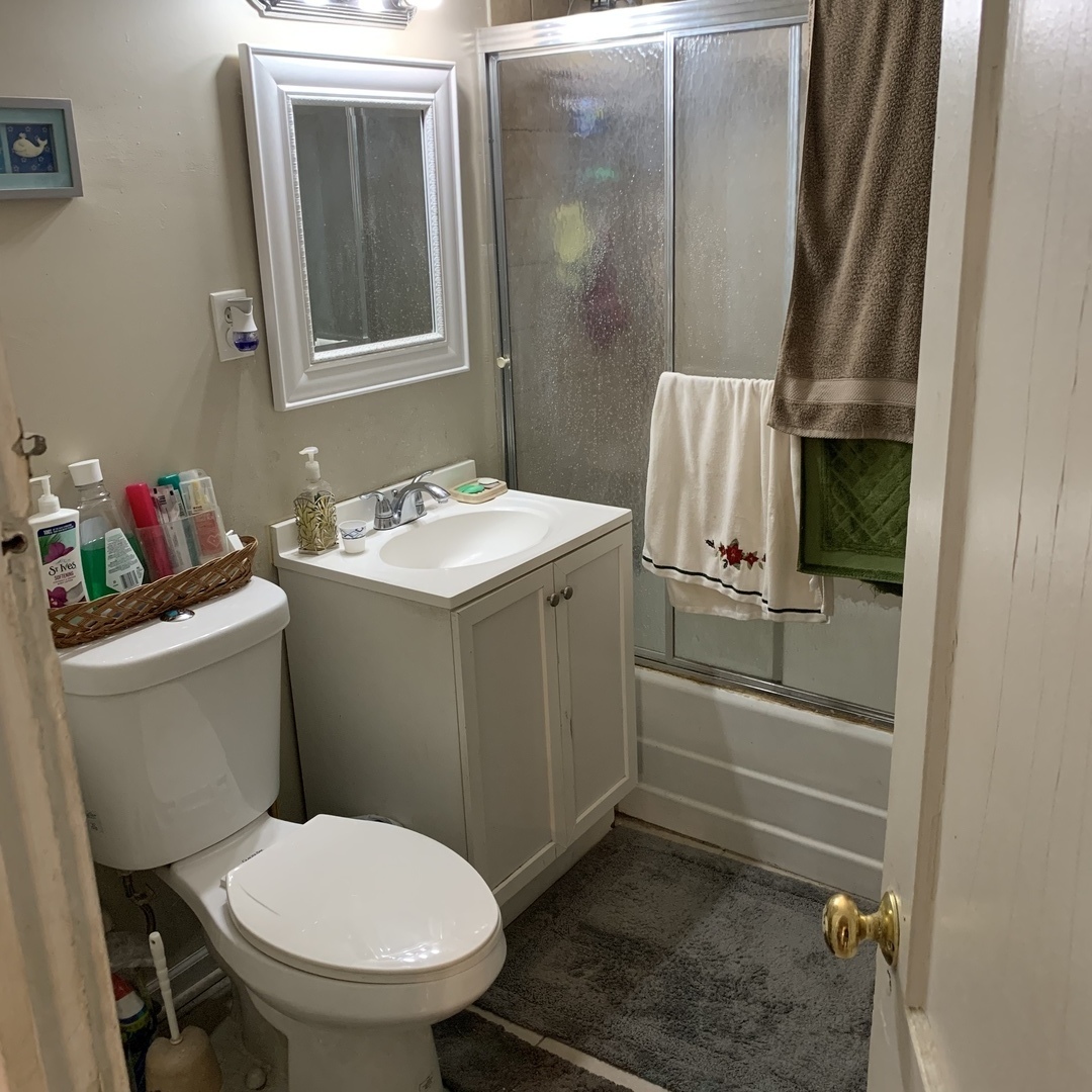 4017 North Spaulding Avenue Chicago, IL 60618 - Photo 30 of 30 a bathroom with a toilet sink and mirror