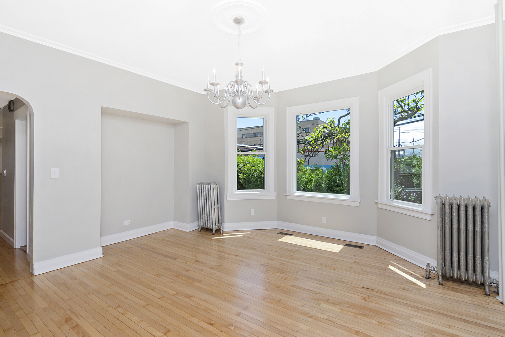4017 North Spaulding Avenue Chicago, IL 60618 - Photo 4 of 30 an empty room with wooden floor and windows