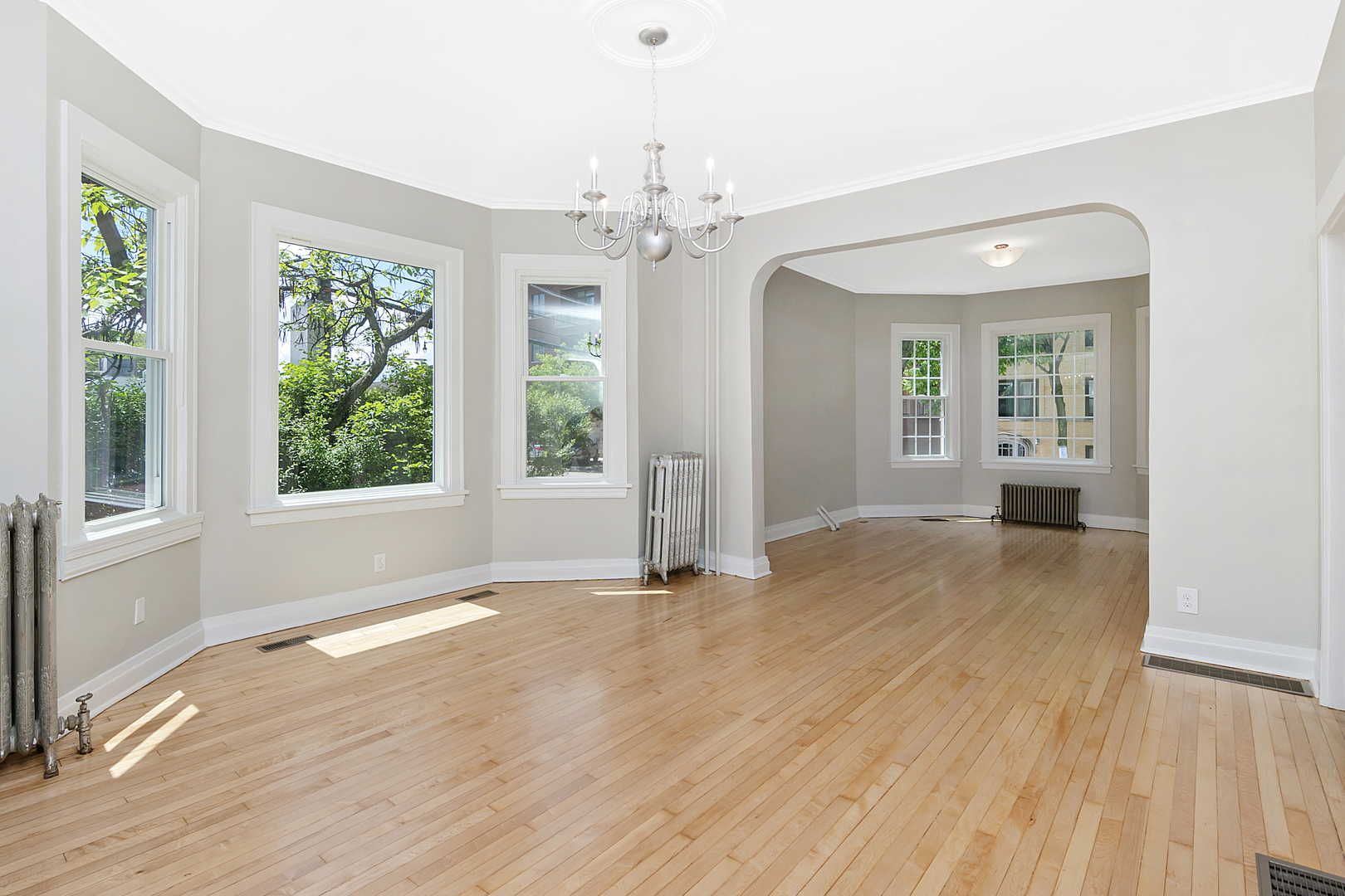 4017 North Spaulding Avenue Chicago, IL 60618 - Photo 5 of 30 a view of an empty room with a window and wooden floor