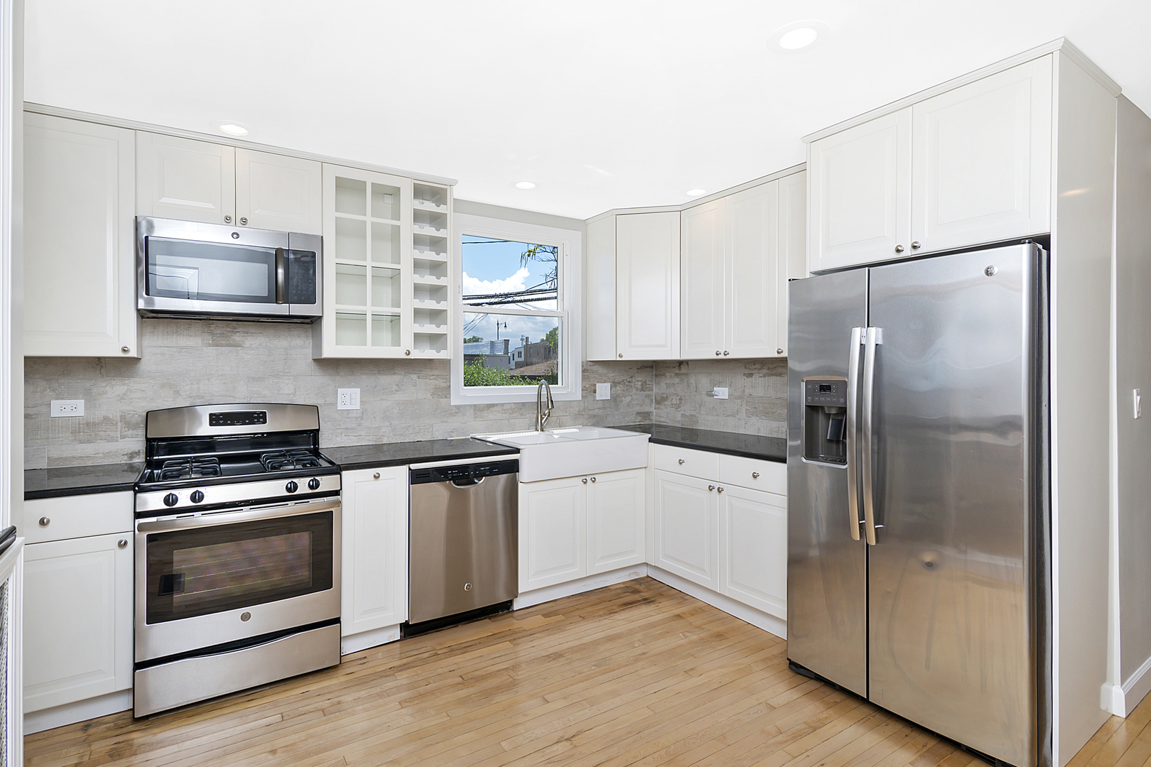 4017 North Spaulding Avenue Chicago, IL 60618 - Photo 7 of 30 a kitchen with stainless steel appliances a refrigerator sink and microwave