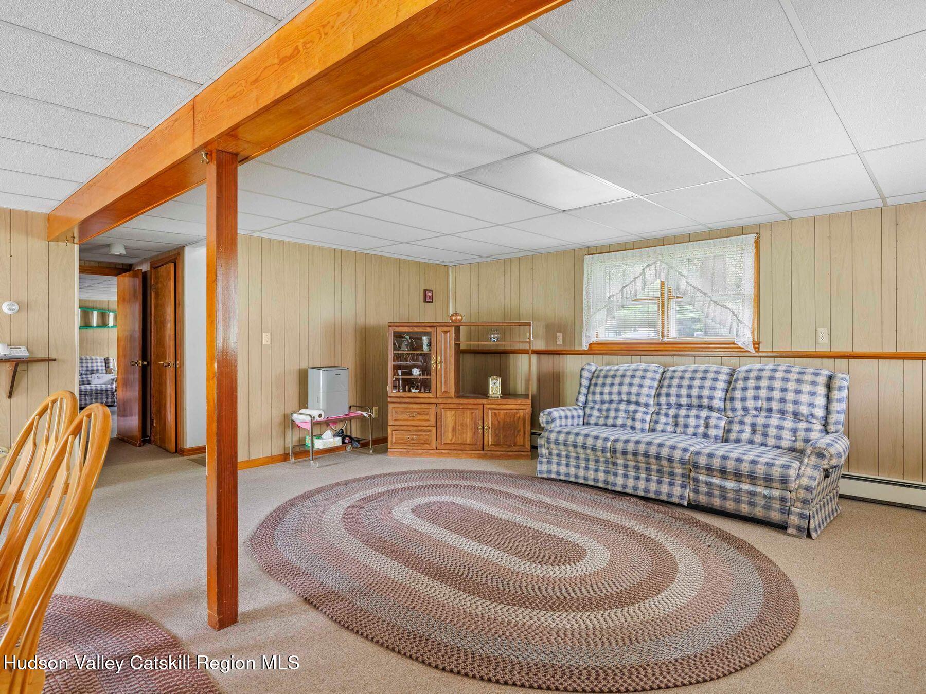 104 New Paltz Road Highland, NY 12528 - Photo 26 of 43 a living room with a couch and a table with wooden floor