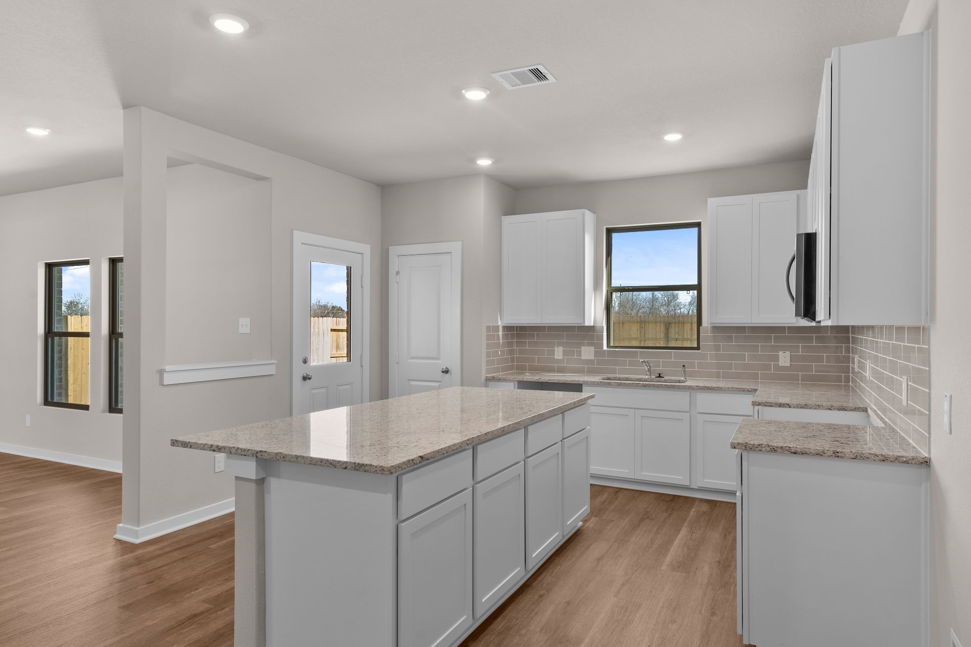 13319 Prado Rdg Lane Rosharon, TX 77583 - Photo 6 of 33 a large white kitchen with a sink and dishwasher with a stove top oven
