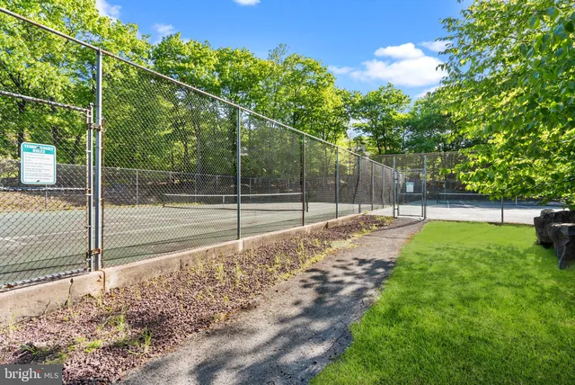 a view of a swimming pool with outdoor seating and plants