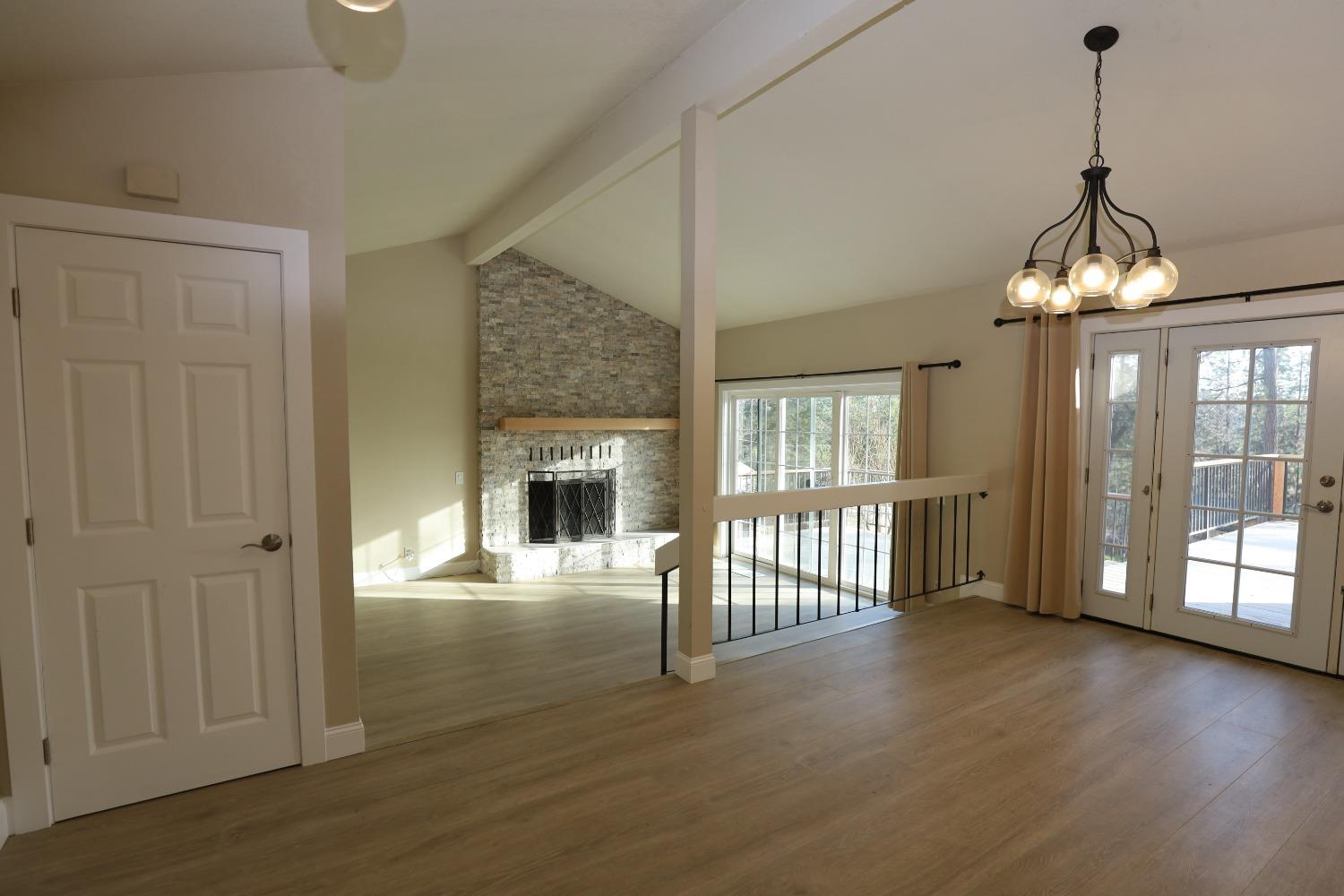 a view of a livingroom with wooden floor and a fireplace