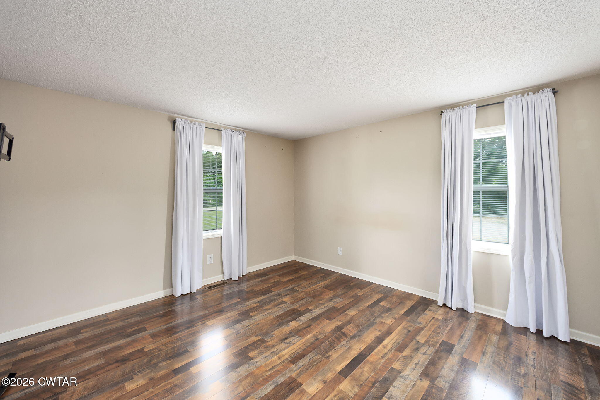 306 Jim Jackson Road Humboldt, TN 38343 - Photo 19 of 29 an empty room with wooden floor and windows