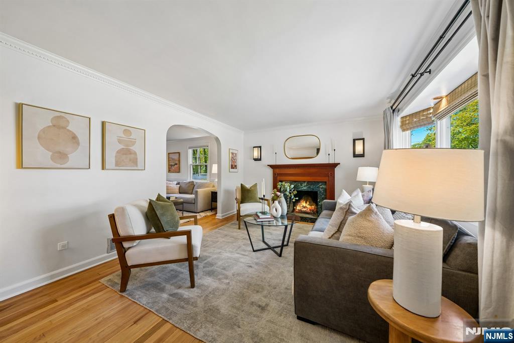 99 Ferncliff Road Bloomfield, NJ 07003 - Photo 6 of 30 a living room with furniture a fireplace and a large window