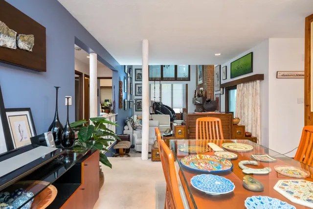 a living room with furniture fireplace and a window