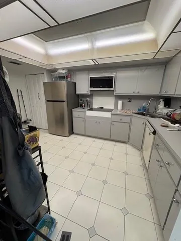 a kitchen with stainless steel appliances a refrigerator and a stove top oven