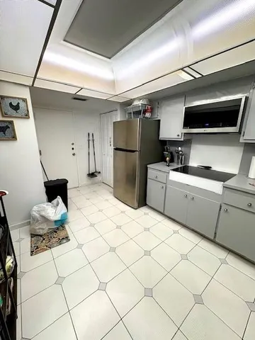 a kitchen with stainless steel appliances kitchen island granite countertop a refrigerator and a stove