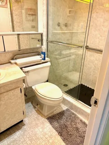 a bathroom with a toilet and a shower