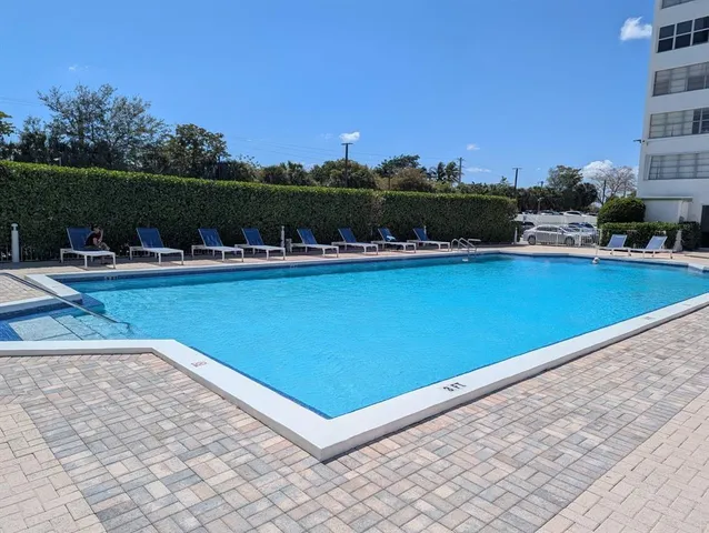 a view of a swimming pool and an outdoor seating