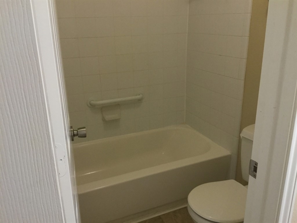 9830 Wing Street Conroe, TX 77385 - Photo 16 of 22 a white toilet and tub sitting next to a shower