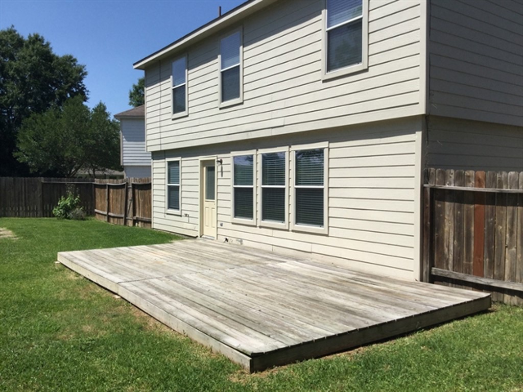 9830 Wing Street Conroe, TX 77385 - Photo 22 of 22 a view of a house with a backyard