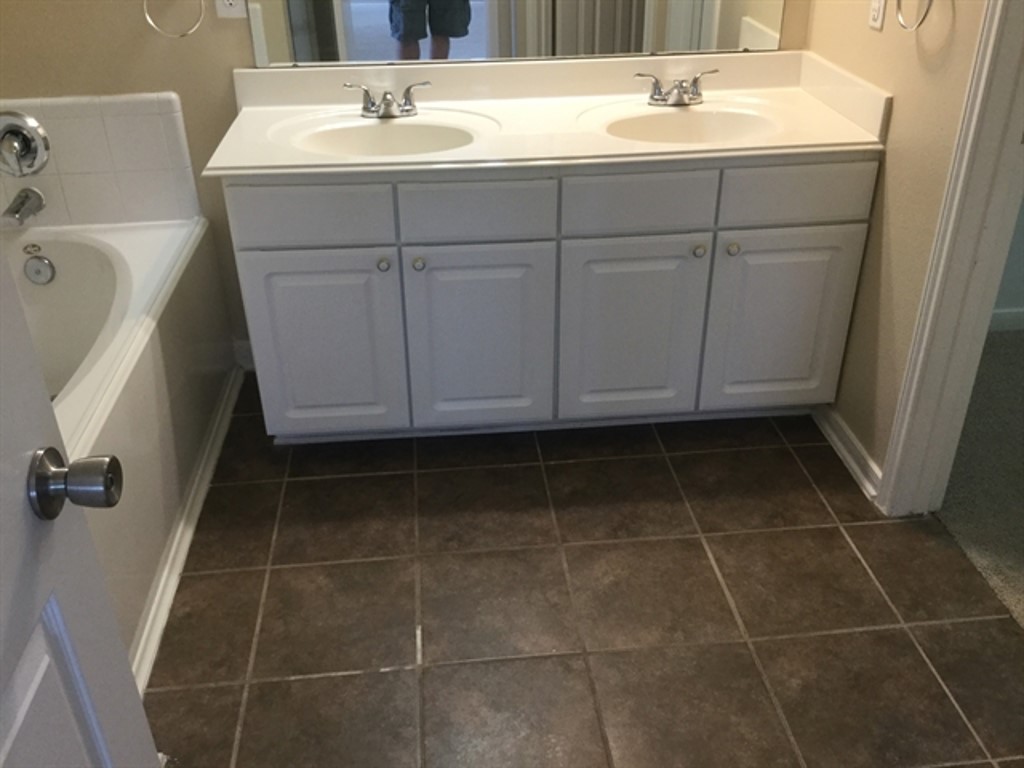 9830 Wing Street Conroe, TX 77385 - Photo 8 of 22 a bathroom with a sink a vanity and a mirror