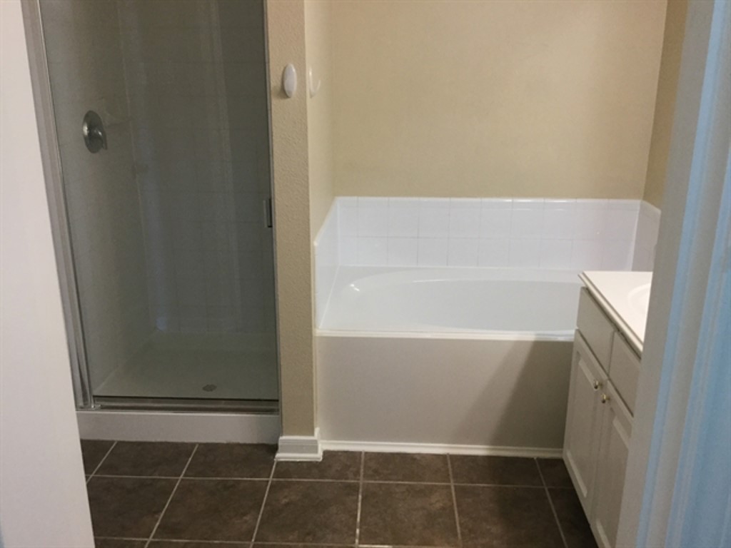 9830 Wing Street Conroe, TX 77385 - Photo 9 of 22 a bathroom with a bathtub