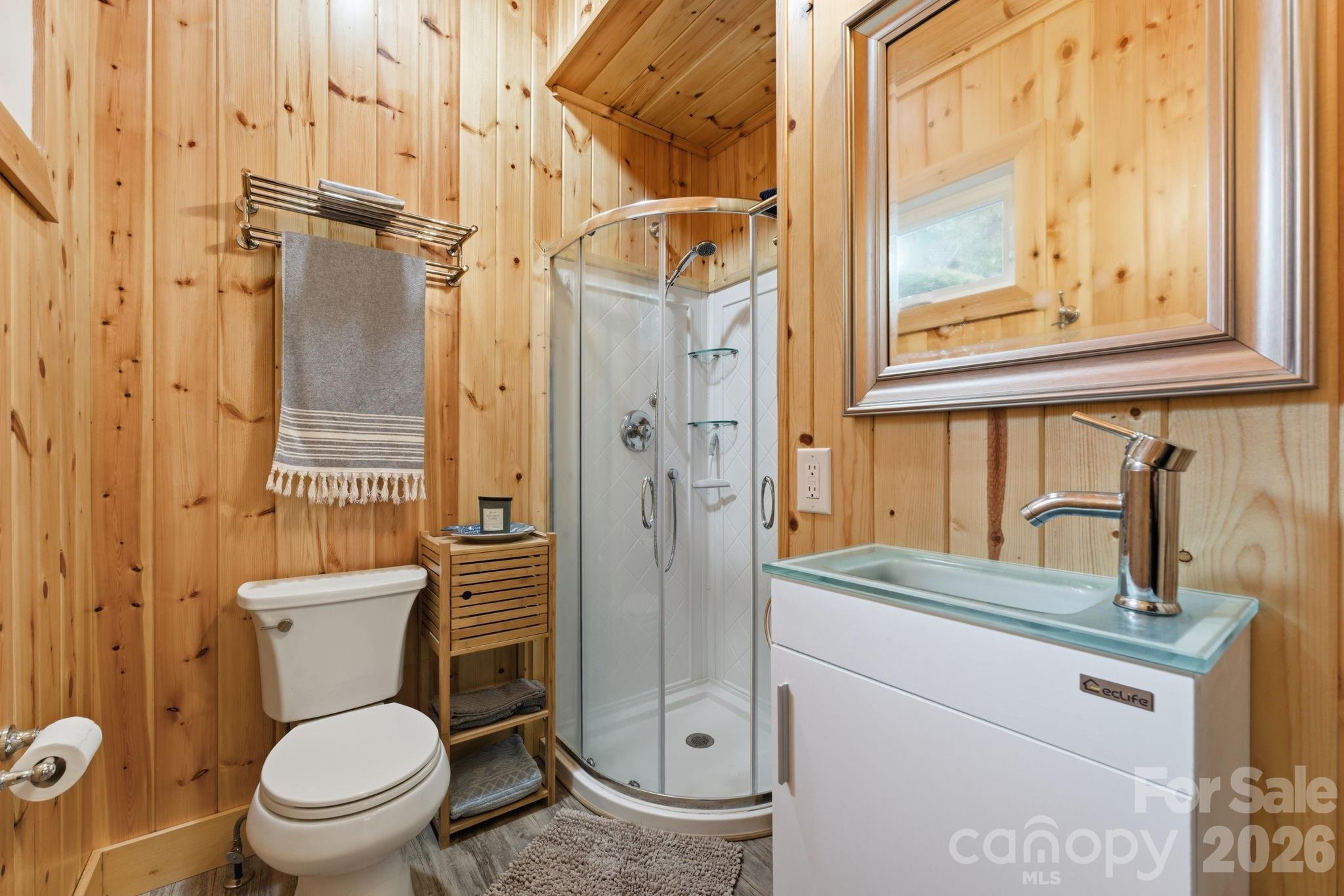 37 Coach Club Highlands, NC 28741 - Photo 18 of 37 a bathroom with a granite countertop toilet sink and a mirror