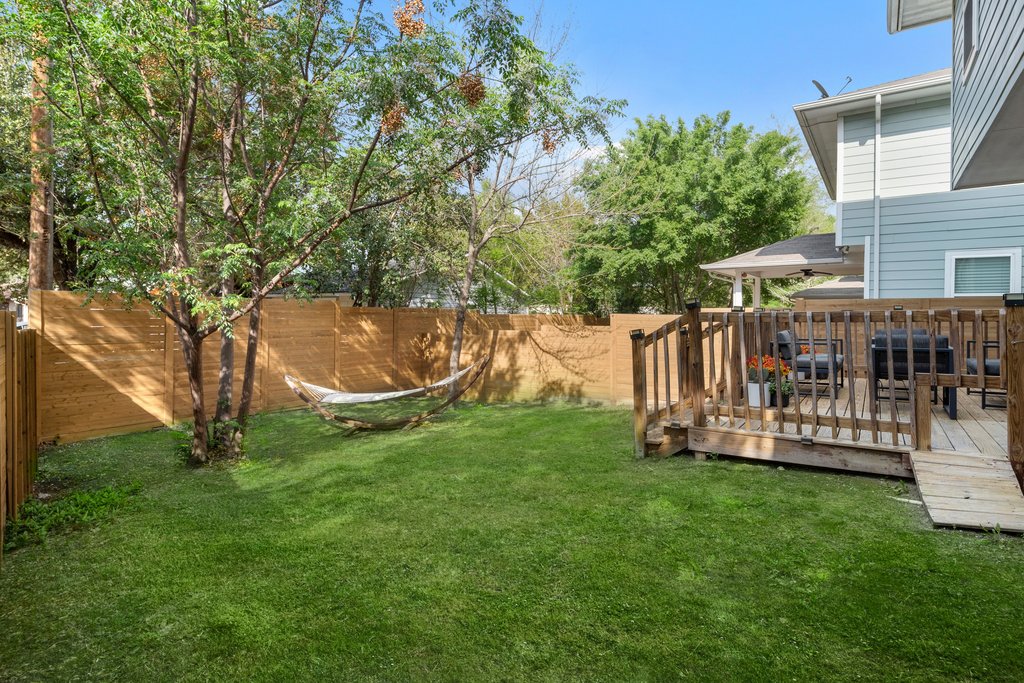 610 Bernstein Street, Unit 14 Austin, TX 78745 - Photo 36 of 39 Fenced backyard with a wooden deck