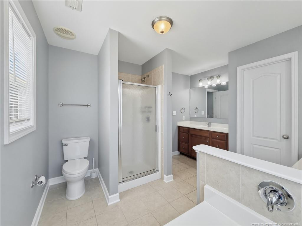 206 Blacksmith Lane Raeford, NC 28376 - Photo 27 of 48 a spacious bathroom with a toilet sink and shower