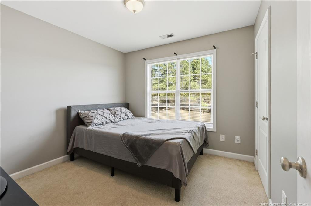 206 Blacksmith Lane Raeford, NC 28376 - Photo 33 of 48 a bed sitting in a bedroom next to a window