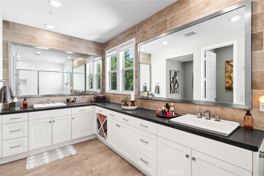 131 Spiral Irvine, CA 92618 - Photo 17 of 39 a bathroom with double sink and a large mirror