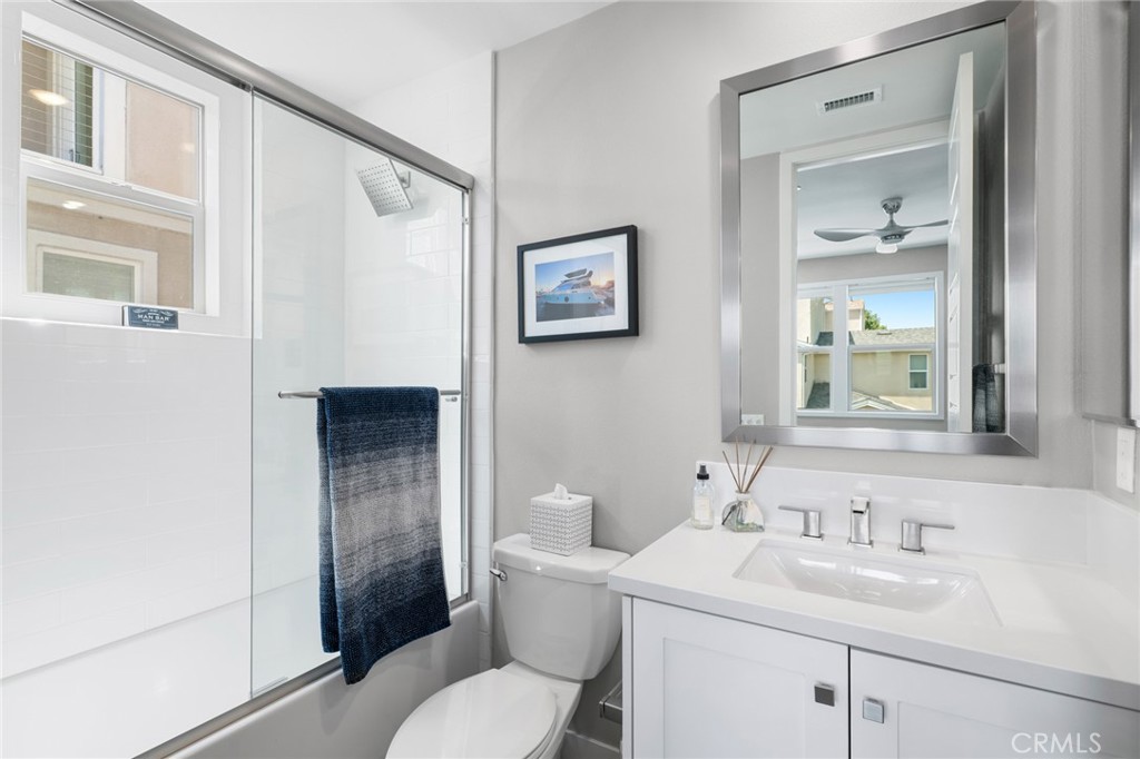 131 Spiral Irvine, CA 92618 - Photo 22 of 39 a bathroom with a toilet sink and mirror