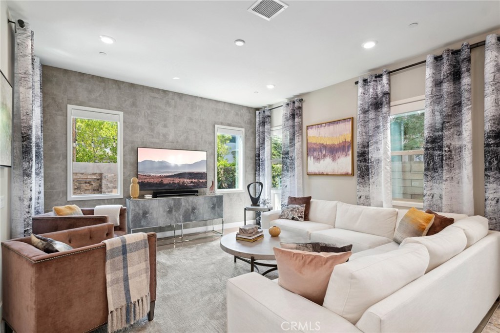 131 Spiral Irvine, CA 92618 - Photo 9 of 39 a living room with furniture and a flat screen tv
