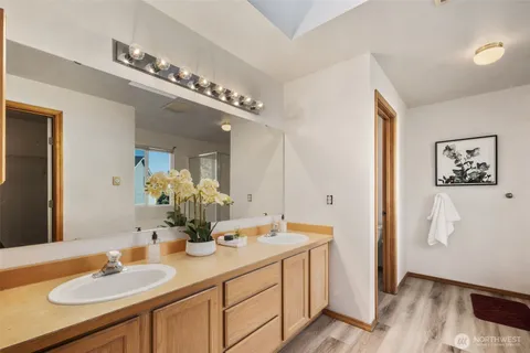 a bathroom with a double vanity sink and a mirror