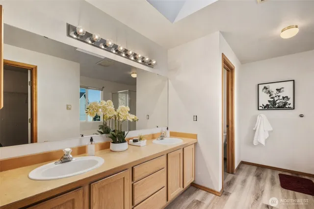 a bathroom with a double vanity sink and a mirror