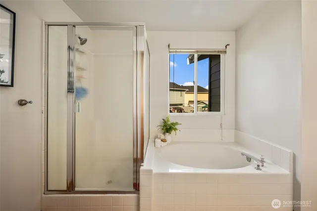 a bathroom with a bathtub and a shower