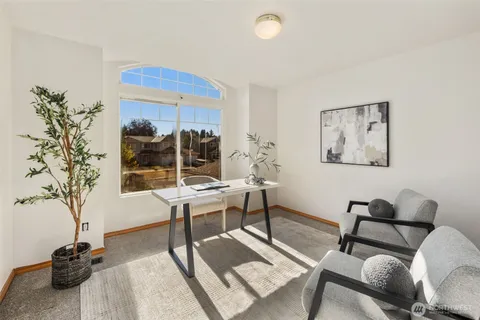 a living room with furniture a table and a potted plant