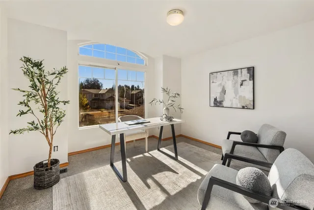 a living room with furniture a table and a potted plant