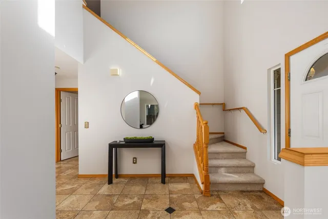 a living room with furniture and a mirror