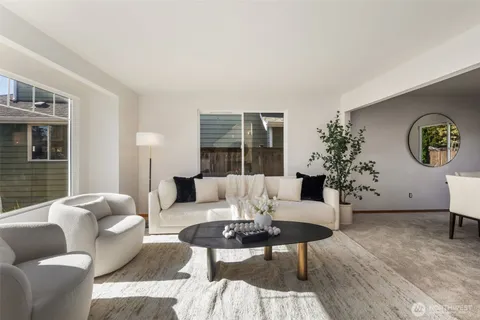 a living room with furniture potted plant and a window