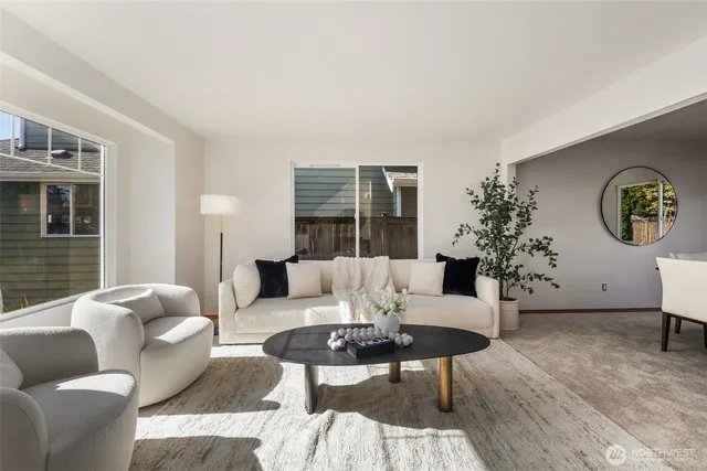 a living room with furniture potted plant and a window