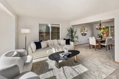 a living room with furniture potted plant and a window