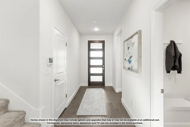 a view of a hallway with windows and closet