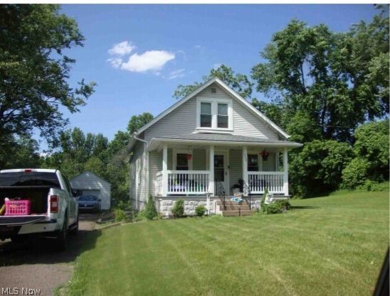 920 Ewart Road Akron, OH 44312 - Photo 1 of 1 View of front facade with a front yard and a porch