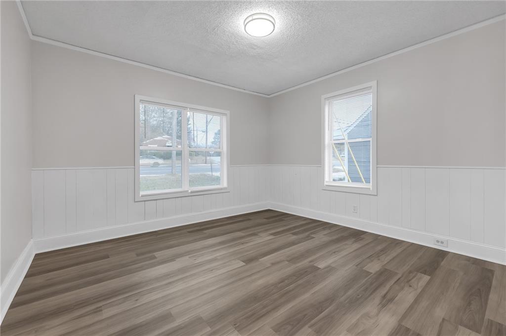 1683 Candler Road Decatur, GA 30032 - Photo 19 of 24 a view of an empty room with wooden floor and a window
