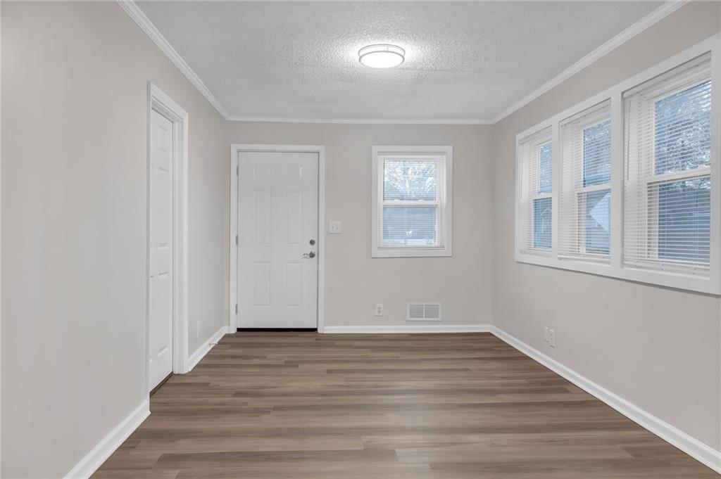 1683 Candler Road Decatur, GA 30032 - Photo 21 of 24 a view of an empty room with wooden floor and a window