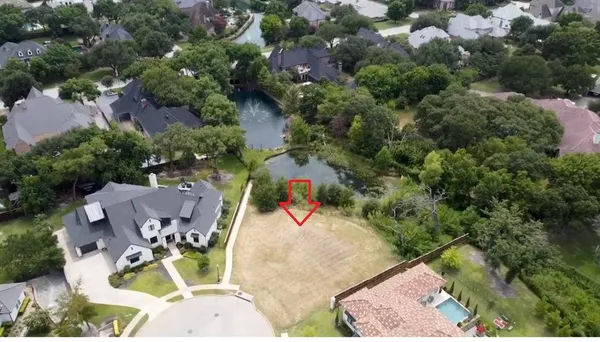 an aerial view of a swimming pool with outdoor seating