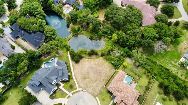 an aerial view of a swimming pool with outdoor seating