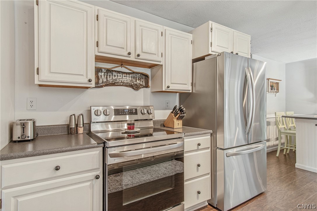 15384 Fuller Road Adams, NY 13606 - Photo 31 of 50 Gleaming stainless steel appliances complement the bright cabinetry and durable flooring in this functional space.