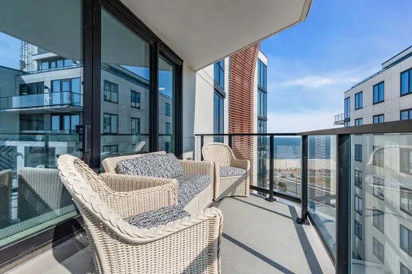 a living room with furniture and a floor to ceiling window
