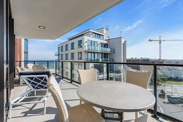a balcony with table and chairs