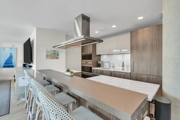 a large kitchen with a table and chairs in it