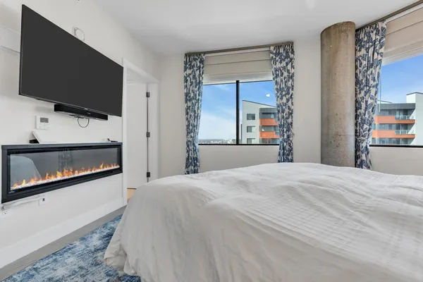 a bedroom with a bed and a window