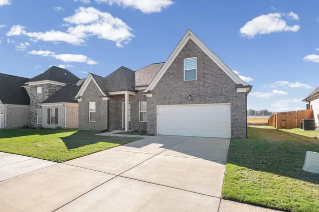 a front view of a house with yard