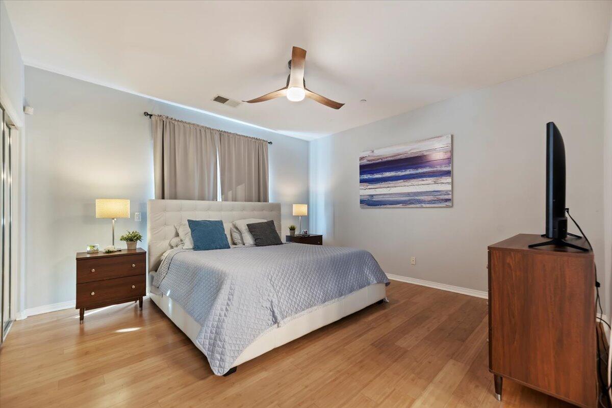 3982 Eastgate N Road Palm Springs, CA 92262 - Photo 21 of 55 a bedroom with a bed and dresser with wooden floor